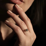 Handgemaakte gouden gedenk ring waarin as, haar of een andere dierbare herinnering zorgvuldig in glas wordt verwerkt geschoten op hand van model.