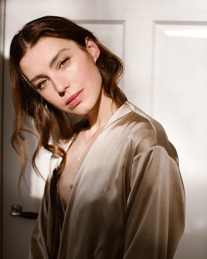 minimalistisch gedenksieraad gedragen door model op lichte achtergrond